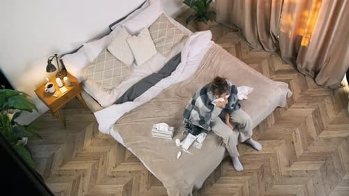 Sick Woman Resting in Bed from Bird's Eye View