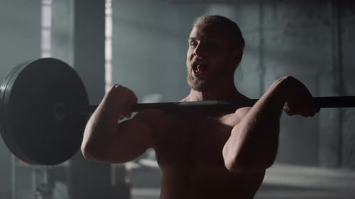 Man Lifting Weights in Gym