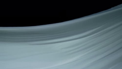 Flowing White Fabric on Black Background