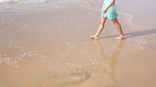 Woman Walking Barefoot on Sandy Beach Shoreline