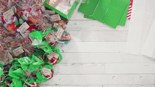 Flat lay. Step by step. Packaging homemade fudge and cookies into a Christmas gift box.