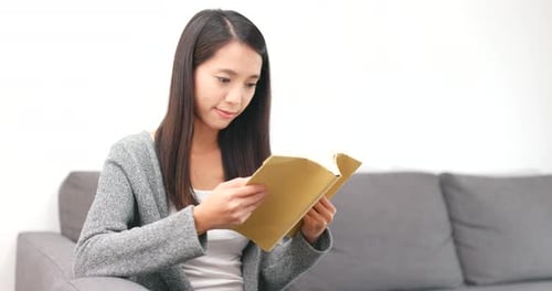 Woman Reading Book at Home