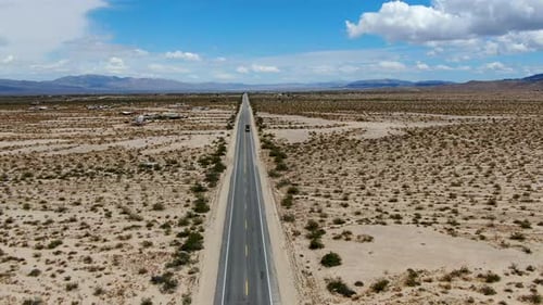 Aerial View of Endless Desert Straight Dusty Asphalt Road in Joshua Tree Park. USA.