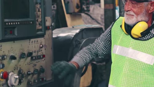 Senior Factory Worker Teach How to Use Machine Equipment in the Factory Workshop