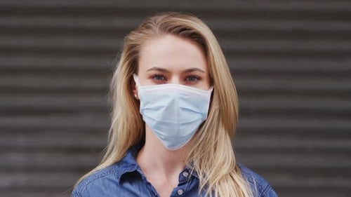 Front view of Caucasian woman wearing a coronavirus Covid19 mask