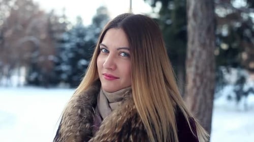 Portrait of a Fashionable Beautiful Girl on a Winter Forest Background