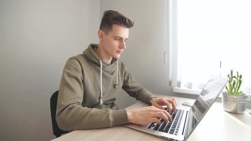 Attractive Office Worker Working Hard at His Cabinet, Programming Something on His Computer