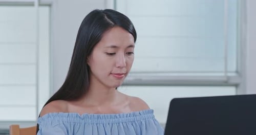 Woman Using Laptop in a Bright Room