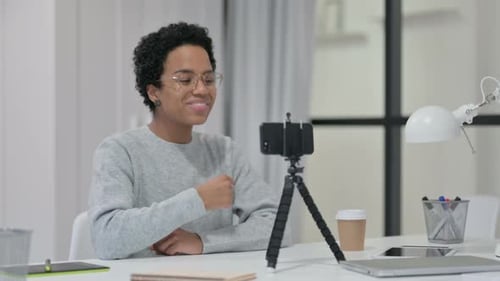 Woman Talking During Video Call at White Desk