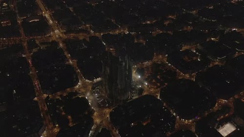 Wide Shot of La Sagrada Familia at Night Glowing in Beautiful Barcelona, Spain
