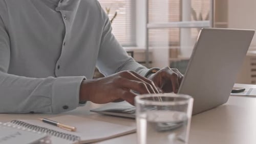 Man Working on Laptop at Office Desk