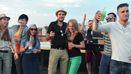 Enthusiastic Friends Dancing at a Rooftop Celebration