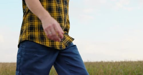 Person Walks By Field on Country Road