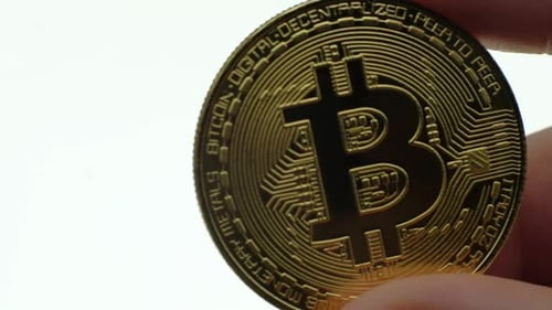Close-up of Golden Bitcoin in Hand