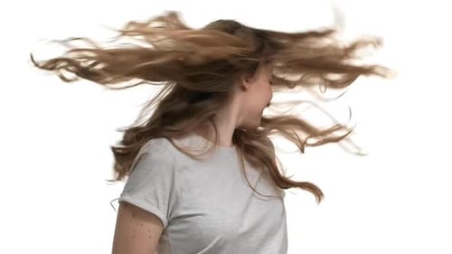 Woman Smiling and Flipping Hair in Studio Setting