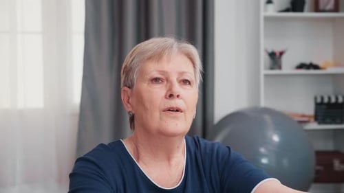 Senior Woman Practicing Breathing Exercises Indoors
