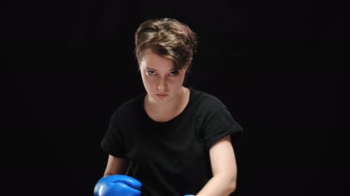 Young Adult Female Boxing and Punching Forward