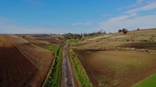 Aerial View of Brown Fields and Country Road