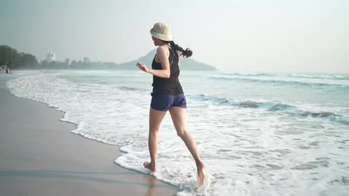 Asian woman happy and relaxing in freedom vacation time at the tropical san beach, natural sea beach