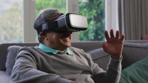 Adult Using Virtual Reality Headset on Couch