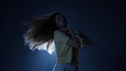 Talented Woman Dancing Contemporary on Background with White Light in Studio