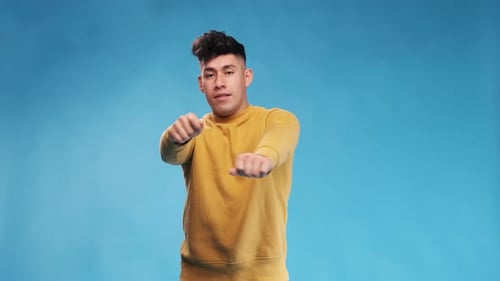 Young Man Dancing in a Yellow Shirt