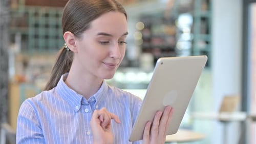 Young Woman Using Tablet Device in Office