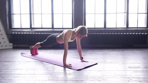 Woman Doing Push-Ups for Fitness Indoors