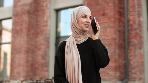 Muslim Business Woman Talking on Mobile Phone Outdoors