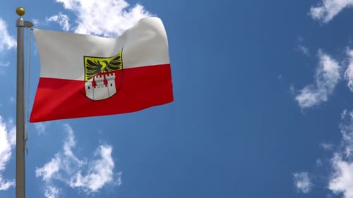 Waving Flag Display Against Blue Sky and Clouds