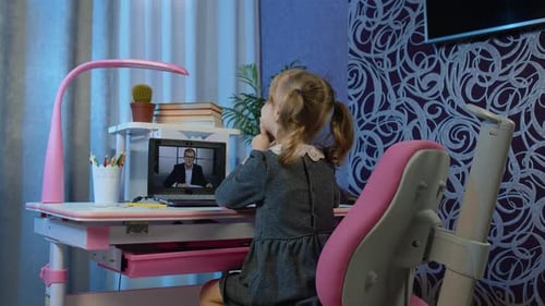 Child Having Online Lesson with Teacher on Laptop