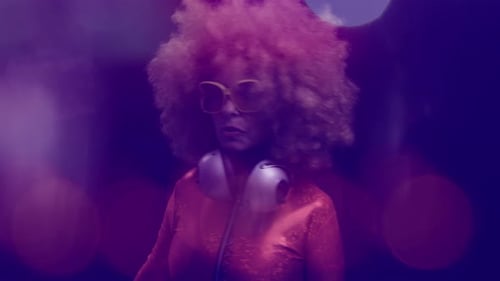 DJ with Afro and Headphones in Disco