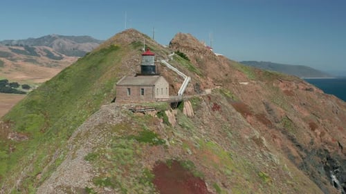 Drone Is Flying To Green Island with Old Lighthouse with Red Roof on the Top,