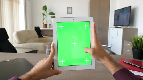 Male Hands Holding a Digital Tablet Personal Computer with Green Screen Chroma Mockup