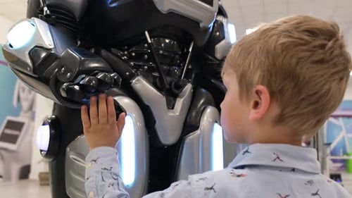 Child Touches Glowing Robot in Urban Environment