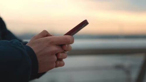Close Up of Male Hands Holding Mobile and Typing Messages