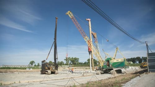 Construction Site with Crane and Pile Driver