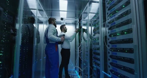 Two Men Performing Maintenance in a Data Center