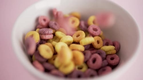 Cereal rings falling in bowl