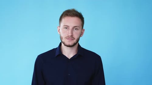 Young Adult Man Close Up Portrait on Blue