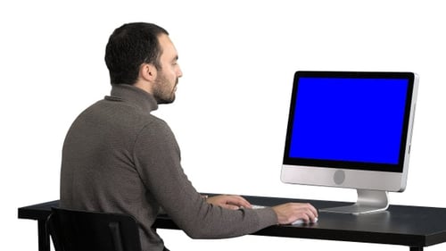 Man Typing at Computer with Silver Blue Screen