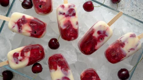 Refreshing Cherry Popsicles on Ice, Top View