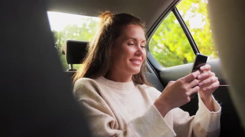 Woman Using Phone in Car on Sunny Day