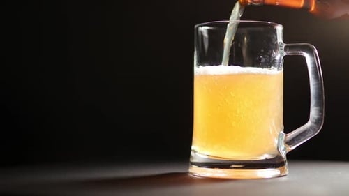 Beer Pouring into Glass Mug