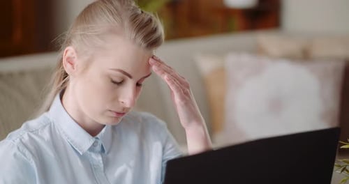 Woman Working with Laptop in Home Environment