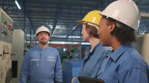 Industry engineer teams inspect machine control panels in manufacturing factory.