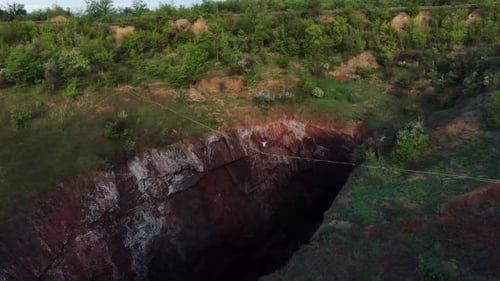 Man Is Walking on a Slackline Extreme Sport View on the Nature Film Grain