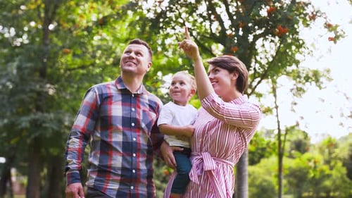 Happy Family Walking at Summer Park