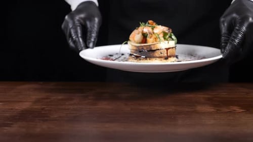Close-up Shot of Male Chef Presenting Dish with Mozzarella Salad on White Plate. Cooking in