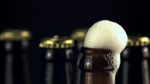 Beer Bottle Overflowing With Foam